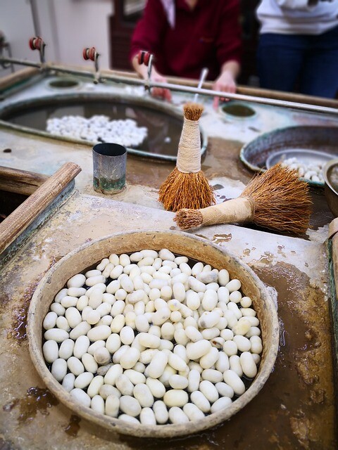 a photo of a bowl full of white silk cocoons