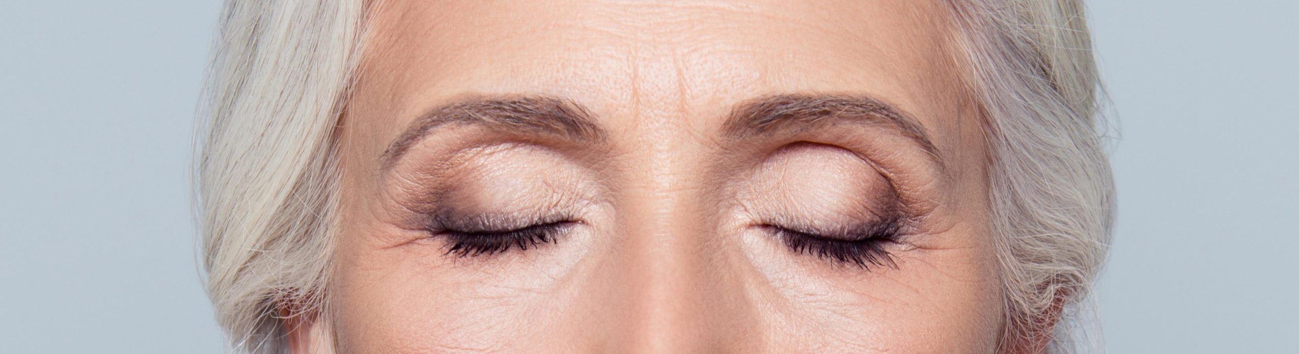 close up of eye make up on woman with gray hair